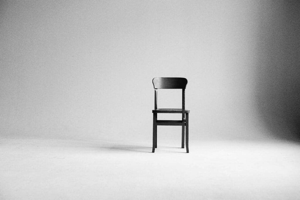 The Culture of More green chair in an empty photography studio